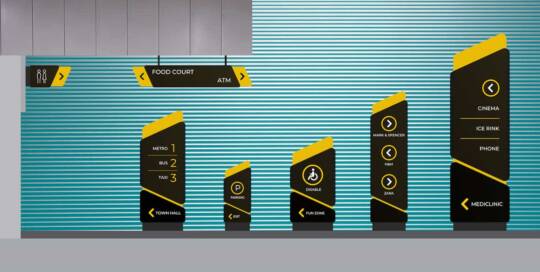 Modern airport signage with directions to food court, ATM, and various amenities, featuring digital display panels with icons for metro, bus, taxi, parking, disabled access, and shopping outlets.