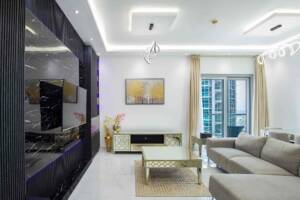 Modern living room with stylish decor, large window views of Dubai skyscrapers, elegant furniture, and contemporary lighting, perfect for digital marketing specialists in Dubai.