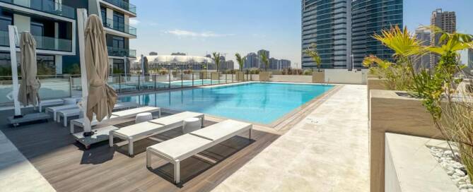 Luxurious rooftop swimming pool in Dubai modern high-rise residential building with sun loungers, umbrellas, and city skyline backdrop, perfect for digital marketing specialists targeting Dubai real estate.